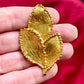 Close up Vintage Yves Saint Laurent 80s 90s gold tone leaf brooch excellent condition on hand 