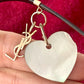 YSL vintage heart-shaped seashell pendant showing minor chip and gold-plated silver hoops.