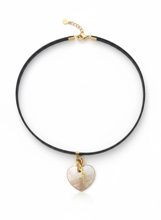 vintage Yves Saint Laurent heart seashell pendant YSL charm mounted on a black leather YSL Parfums necklace.