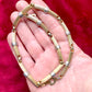 Skin tone Vintage Christian Dior two-tone necklace with ribbed accents displayed on a red velvet background