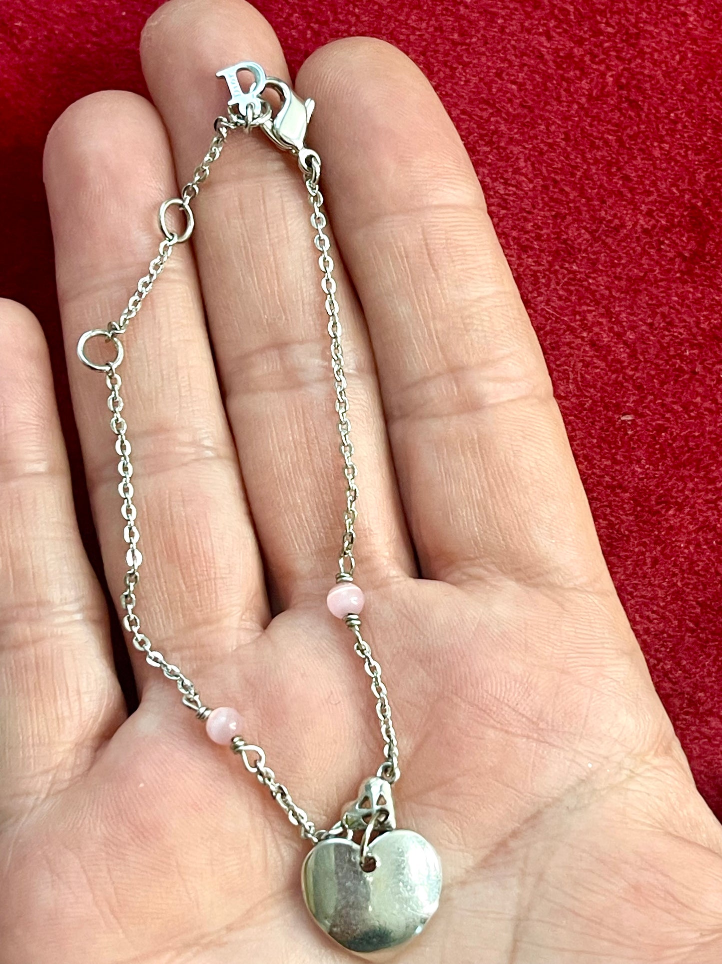 Backside view of Vintage Dior silver tone rose beads chain bracelet with D charm signed displayed on hand 