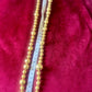 Full view of 45 cm Yves Saint Laurent vintage gold-tone necklace with graduated beads using a measuring tape 