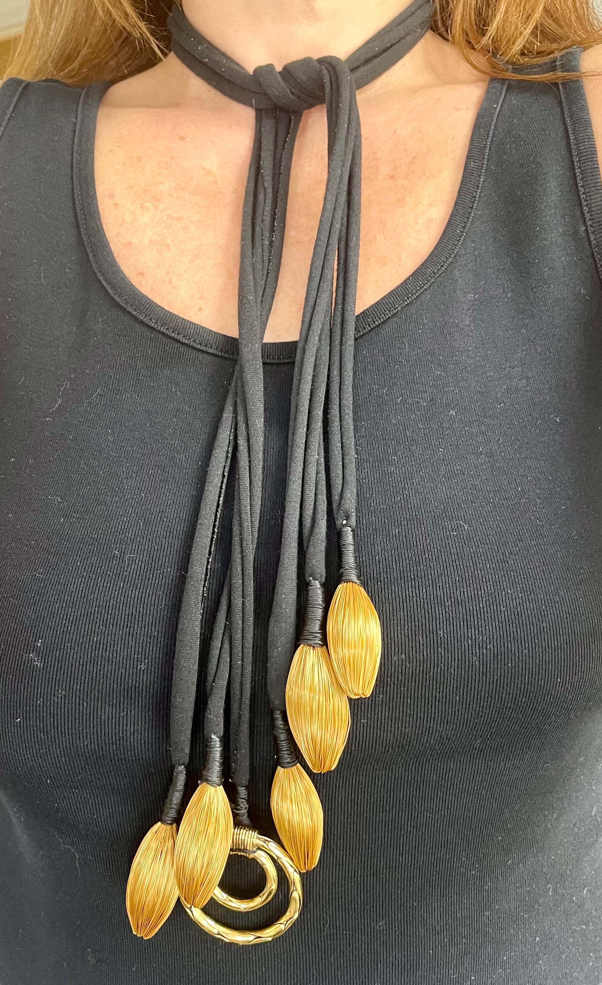 Close up at Vintage Yves Saint Laurent YSL scarf holder one of a kind art textile statement necklace worn on chest 