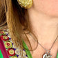 Worn by a model Vintage 80’s clip on earrings, repurposed with 18KG classic designer collectibles 
