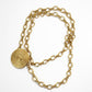 Yves Saint Laurent vintage 80s scarf holder Gold chain necklace on a white background