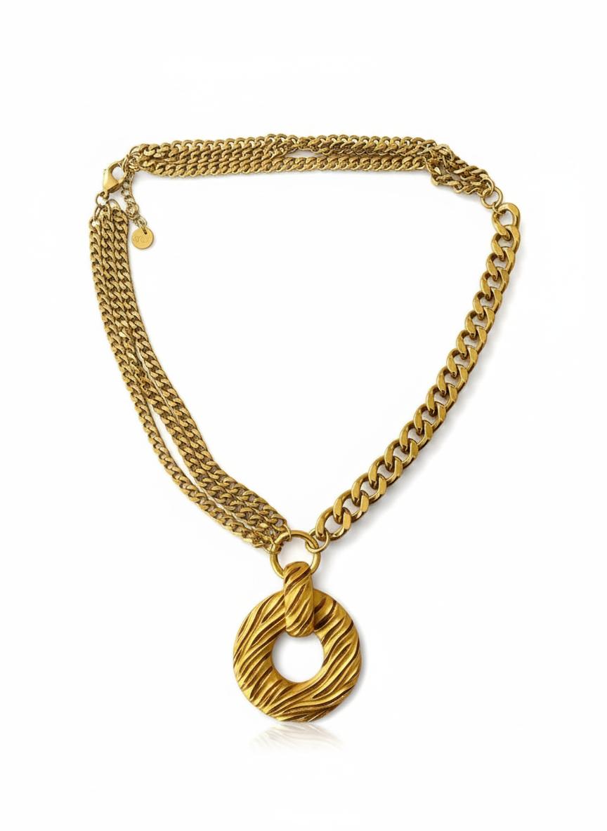Yves Saint Laurent vintage pendant  paired with stainless steel chain necklace on white background 
