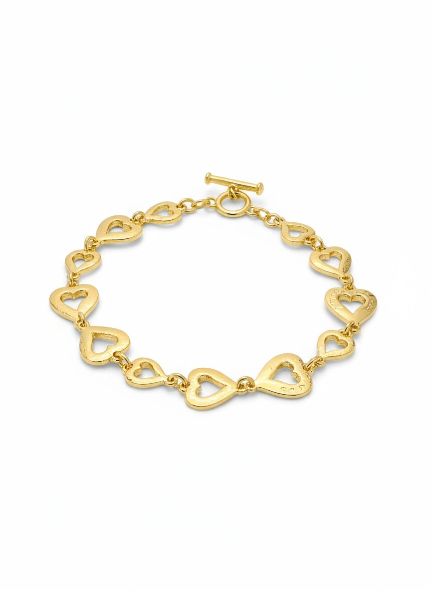 Gold heart-shaped bracelet on a white background