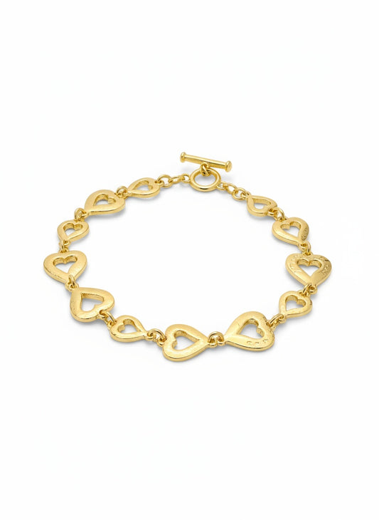 Gold heart-shaped bracelet on a white background