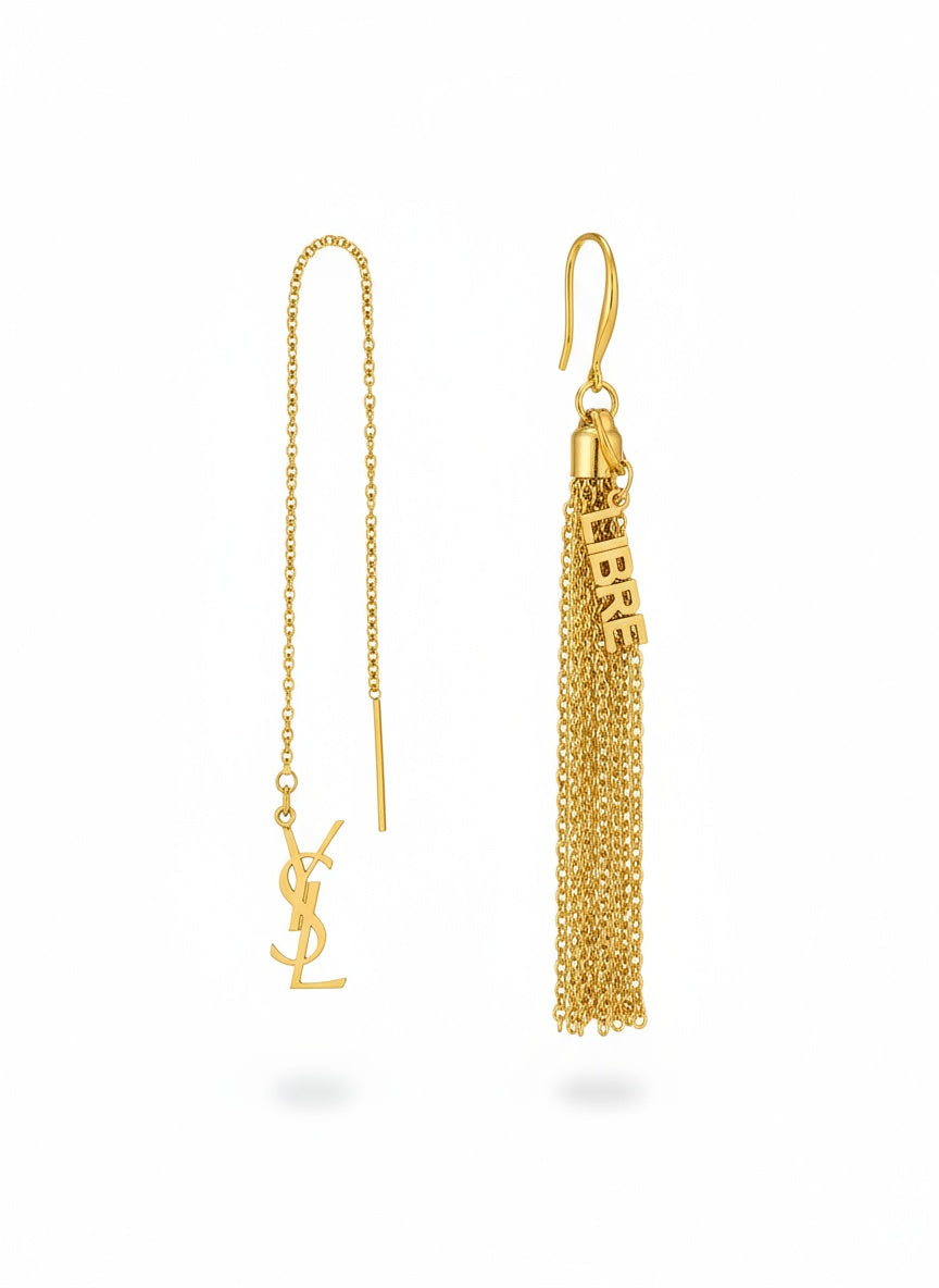 Gold tassel earring repurposed with chain and Yves Saint Laurent Libre charms on a white background