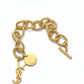 Gold chain bracelet with Yves Saint Laurent logo on a white background