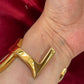 Auténtico brazalete YSL de color dorado de Yves Saint Laurent